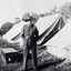 A sergeant standing beside row of tents.