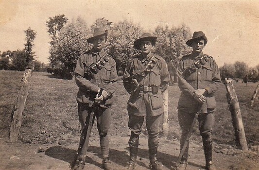 Three lighthorsemen standing near broken fence