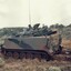 Army tracked vehicle in semi desert.