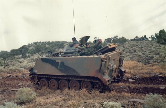 Army tracked vehicle in semi desert.