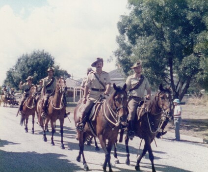 Soldiers on horses in street