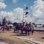 Soldiers on horses near railway warning lights 