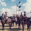 Soldiers on horses at railway warning lights