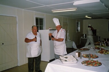 Two soldier cooks relaxing after preparing food