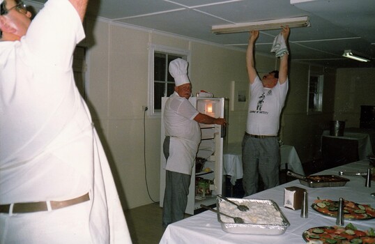 Regimental cooks making adjustments to light