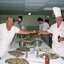 Two army cooks preparing food