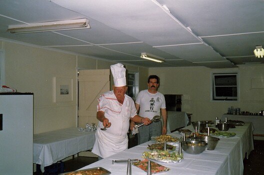 Army cooks making final adjustments to meal.