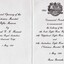 Folded card with printing and emblem.
