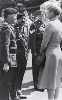 Three soldiers and lady in civilian dress and hat