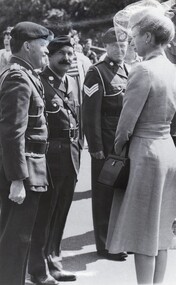 Three soldiers and lady in civilian dress and hat