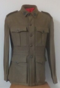 Soldier's jacket with buttons and badges on it.