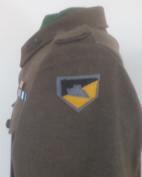 Soldier's jacket with colouful badge on shoulder