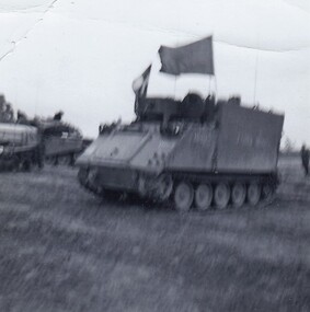 Large armoured vehicle flying a huge flag