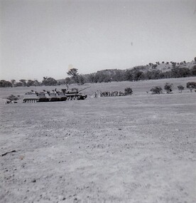 Tank and carriers in a paddock