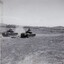 Tanks in paddock firing guns.