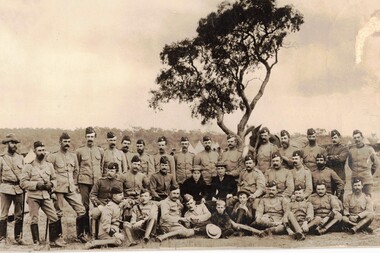 Group of soldiers and visitors at camp