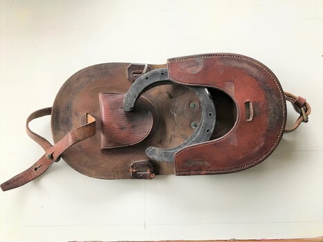 folding leather wallet showing horse shoes.