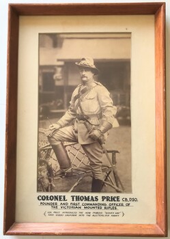 Framed photograph of soldier with hat and gloves