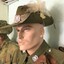 Portrait of mannequin wearing hat with plumes on side of brim.