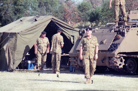 SFoldilers near tent and tank.