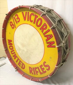 Large drum with sign around edge.