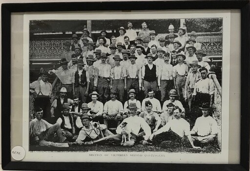 Large group of men dressed in trousers and shirt sleeves.