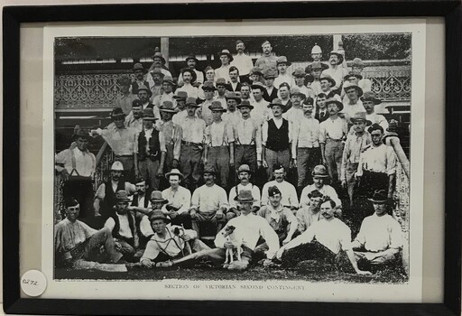 Large group of men dressed in trousers and shirt sleeves.