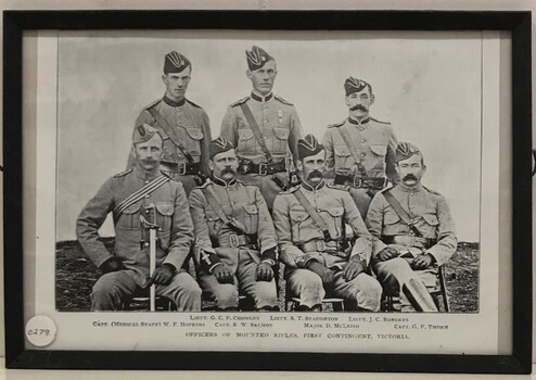 Group of army officers, one with sword,