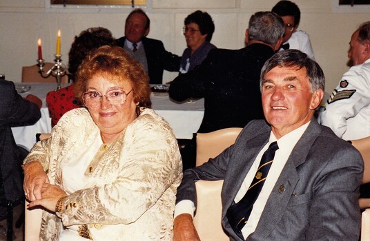 Couple sitting at dining table.
