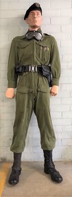 Mannequin in green overall with belt and pistol pouch
