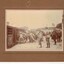 Soldiers pushing horses into stalls on train.