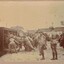 Soldiers pushing horses into rail wagon.