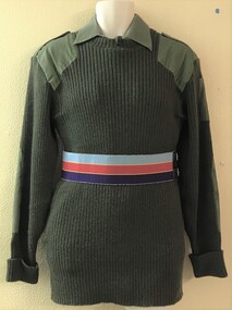 Large woolly jumper with coloured belt.