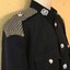 Woven metal covering in shoulders of jacket