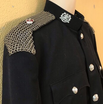 Woven metal covering in shoulders of jacket