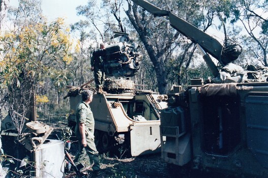 Crane lifting engine out of tank.