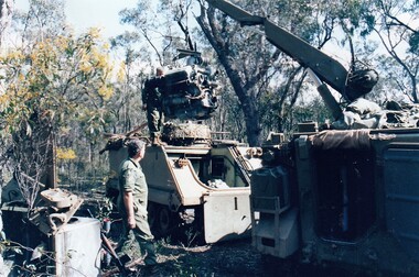 Crane lifting engine out of tank.