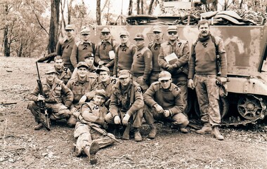 Group of soldiers in front of tank