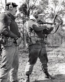 Two soldiers, one firing gun