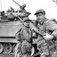 Two soldiers cleaning tank gun.