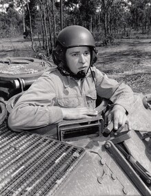 Soldier wearing helmet in tank