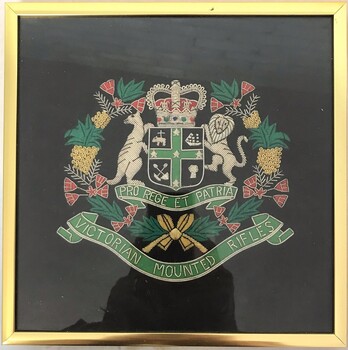 Framed embroidered badge with kangaroo, lion and wattle.