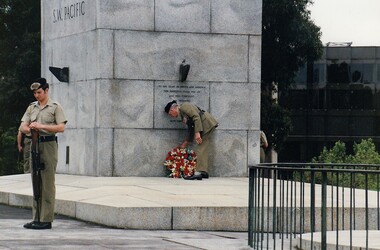 Soldier laying wreath at memorial