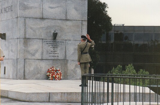 Soldier saluting  at a War Memorial