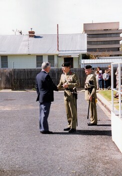 Civilian and soldier shaking hands
