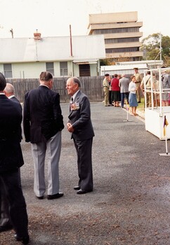 Two former soldiers talkiing on parade ground