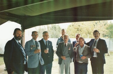 Former soldiers with drinks in tent