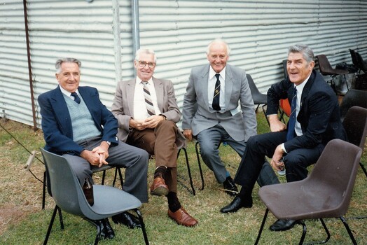 Group of 4 men seated