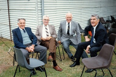 Group of 4 men seated