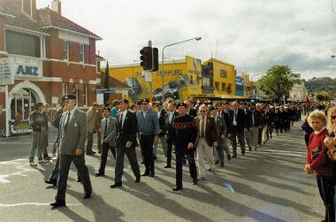 Former soldiers marching in city street